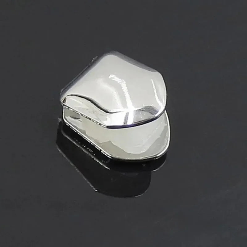 Shiny silver metal grill with a smooth polished surface and rounded edges single tooth caps for hip hop grills