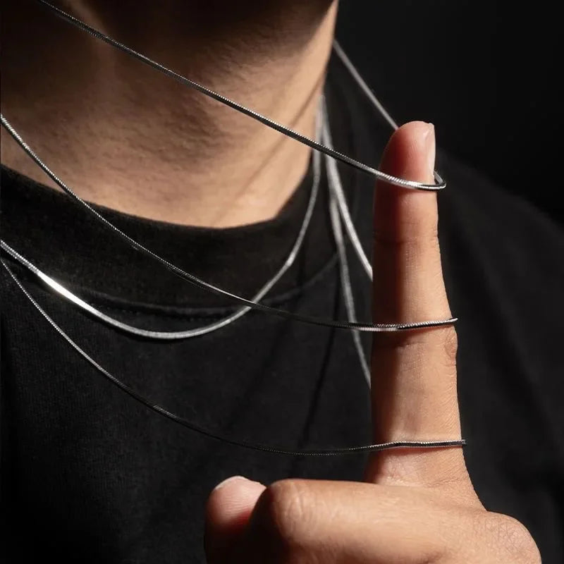 Silver snake link chain stainless steel necklace for men and women displayed against a dark background for male jewelry gifts