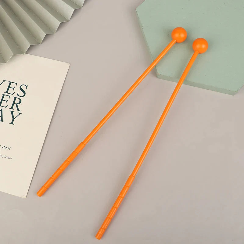 Bright orange plastic percussion drum sticks with rounded spherical ends suitable for mallets drumsticks adults and kids