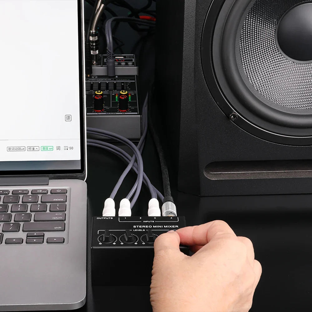 Black 4-channel mini passive stereo mixer with white knobs and labeled input output ports for live studio use