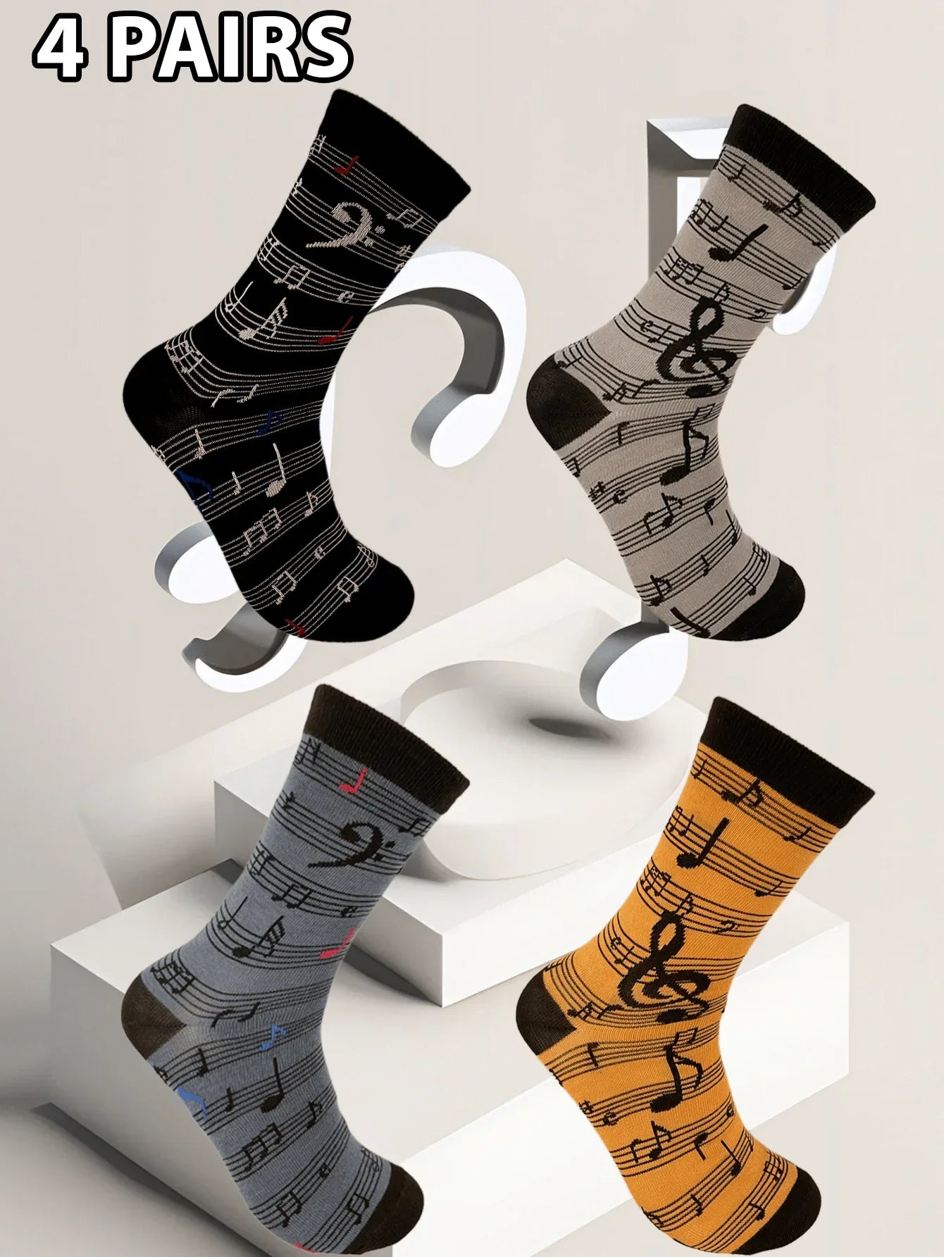 Four pairs of men’s fashion music symbol socks in black gray blue and orange with a pattern sock combination design