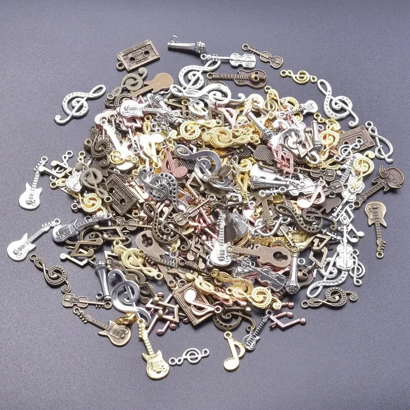 A collection of vintage random diy bulk violin guitar musical note charms in metallic colors for diy jewelry making