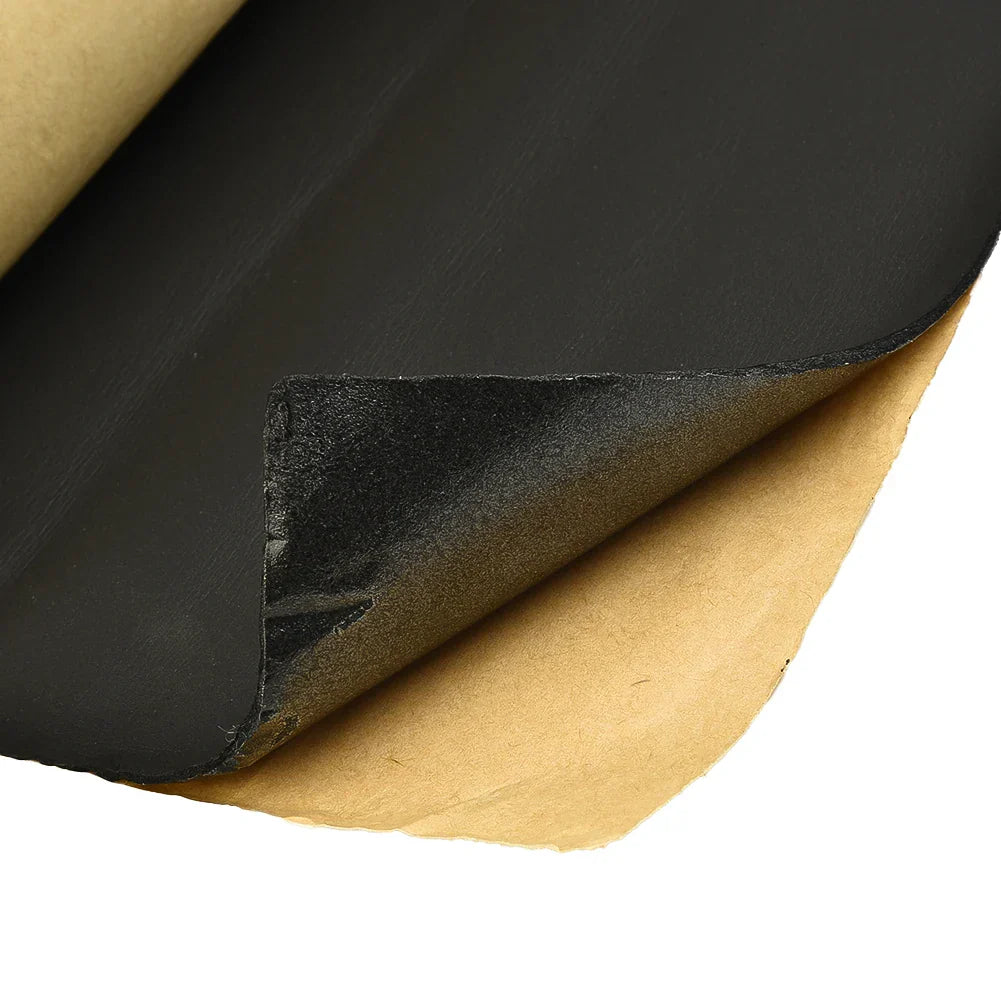 Black rubber car soundproof deadening foam sheet with matte finish peeled back to show adhesive insulation warm foam backing