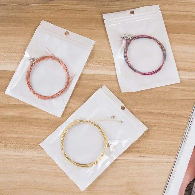 Three packaged guitar string brass with hexagonal steel core in copper rose gold and silver finishes 6pcs set universal