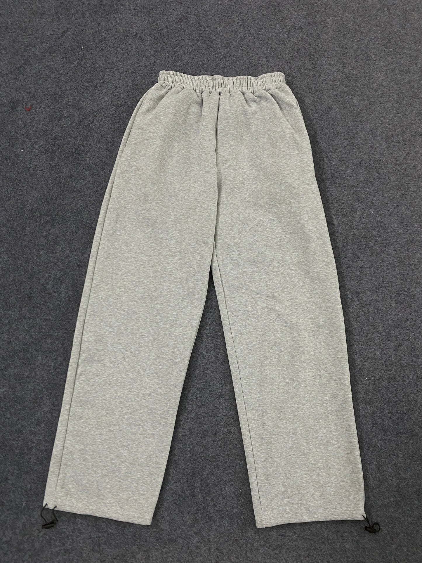 Gray heathered sweatpants with elastic waistband and ankle drawstrings featuring american hip hop personality design