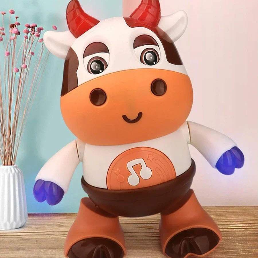 A cheerful orange and white baby dancing cow electric music plush toy with red horns blue hands and musical note emblem