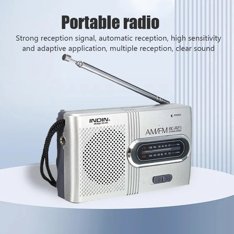 Silver infin portable am fm radio receiver player with telescopic antenna and black strap for lightweight handheld use