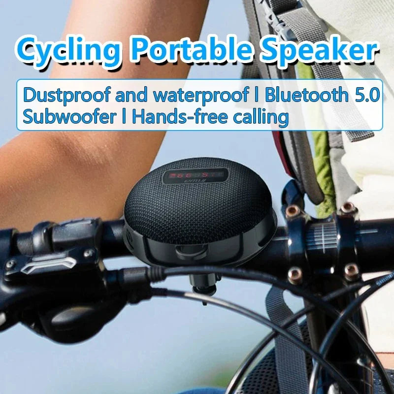 Black circular som bluetooth speaker with mesh grille and digital display mounted on bicycle handlebars as wireless mini subwoofer