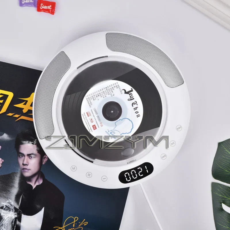 White circular cd player with built-in speakers and digital display showing 0021 featuring player surround sound and radio bluetooth usb mp3 disk portable functions