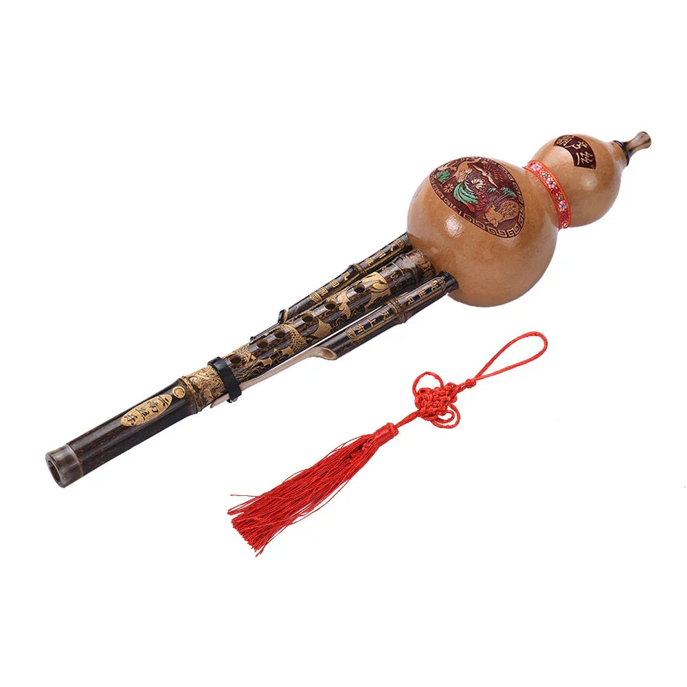 Hand-carved black bamboo hulusi gourd flute with intricate gold detailing and red tassel ethnic musical instrument key of C