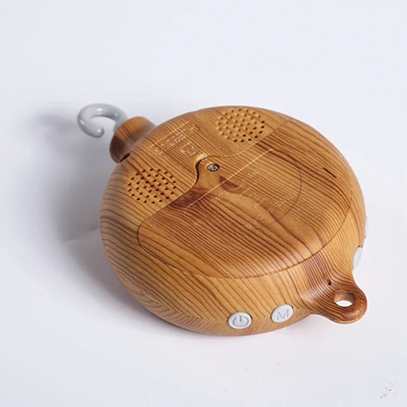 Wooden crib bell rotary music box with natural grain finish, two buttons, and hook for baby bed hanging toy enhancing hand-eye coordination