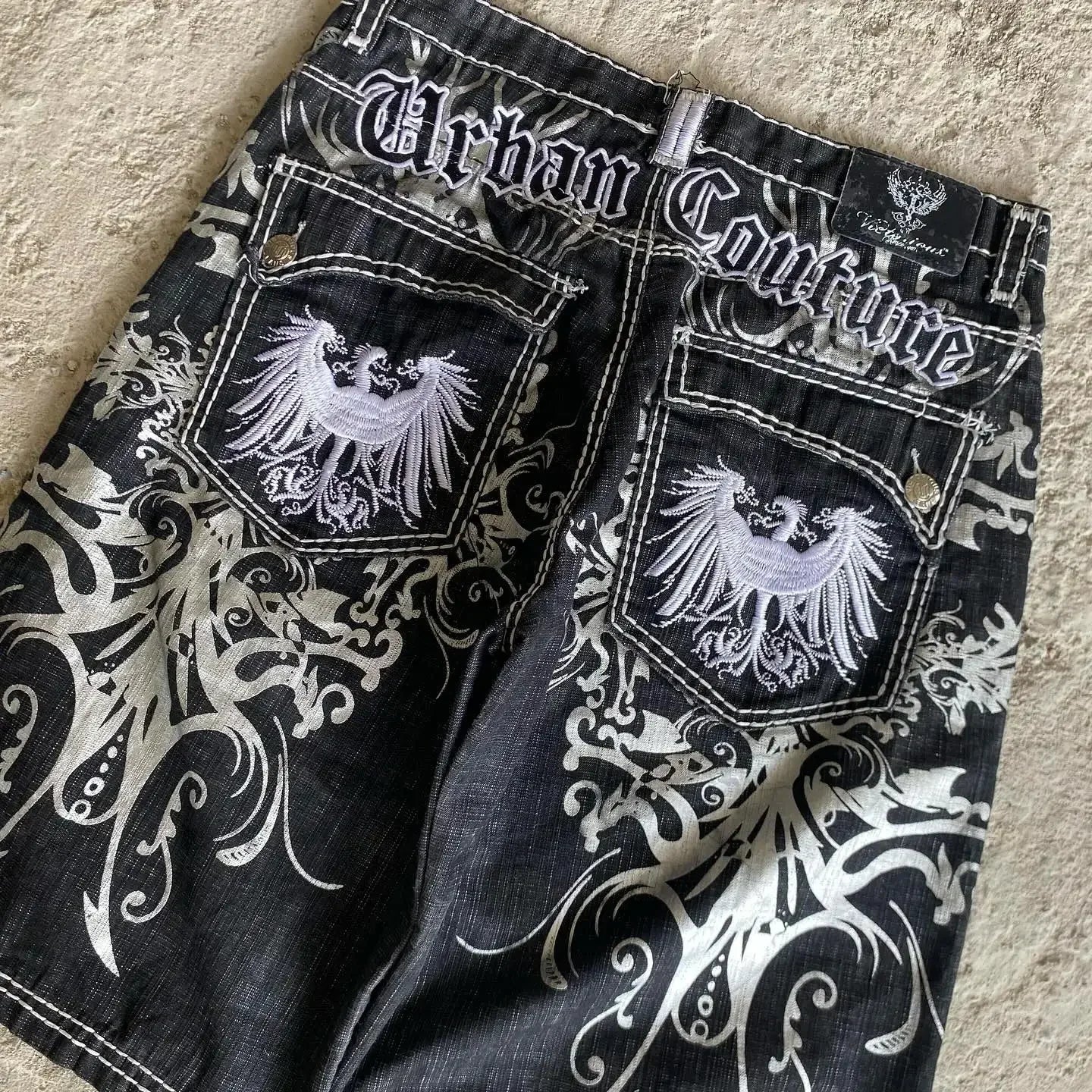 Black urban couture denim shorts with white embroidered phoenix and swirl patterns hip hop heraldic basketball shorts y2k