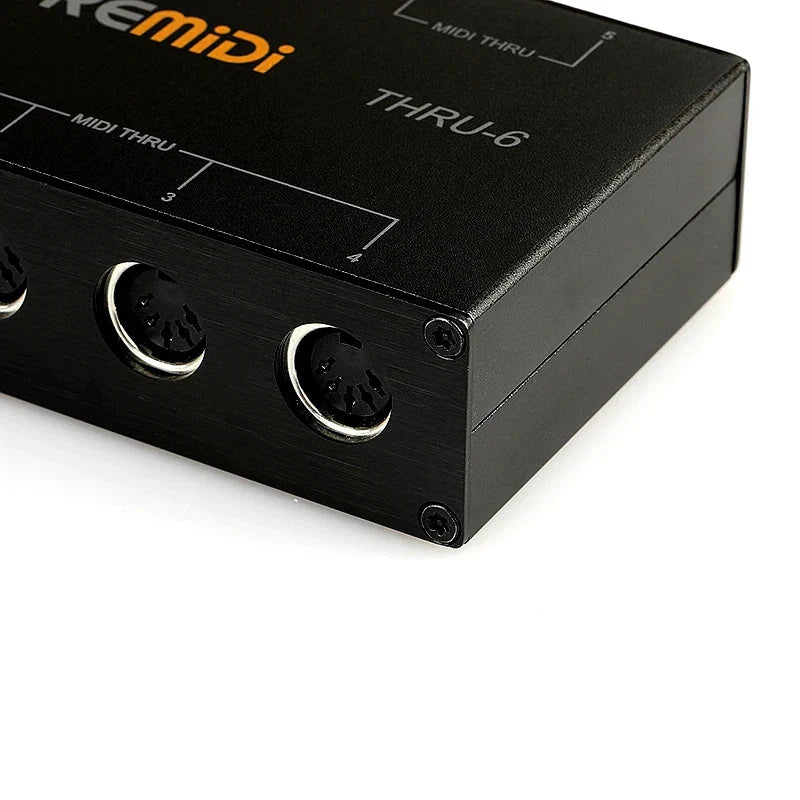 Black metallic doremidi midi thru 6 box controller with three circular ports and orange branding midi five-pin interface