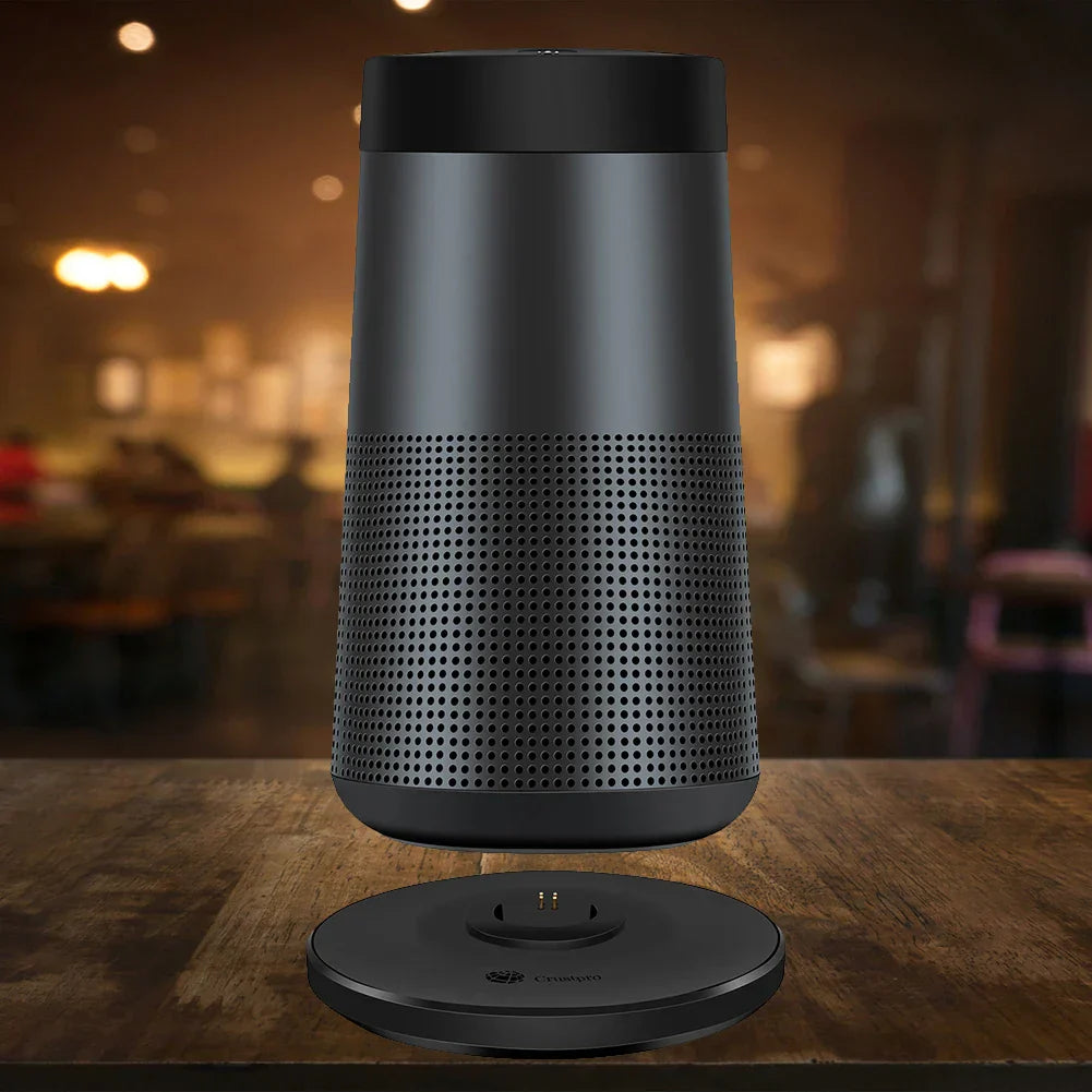 Black bose soundlink revolve speaker with perforated midsection on matching charging cradle holder case speaker accessories