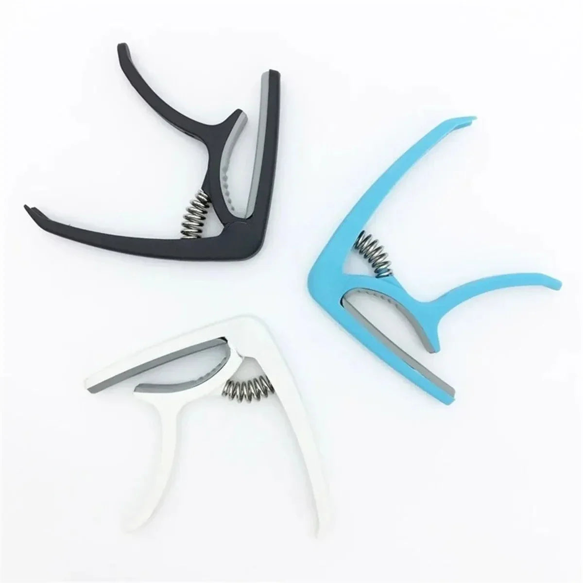 Black blue and white plastic guitar capo with metal spring for acoustic classic guitar and musical instrument ukulele use