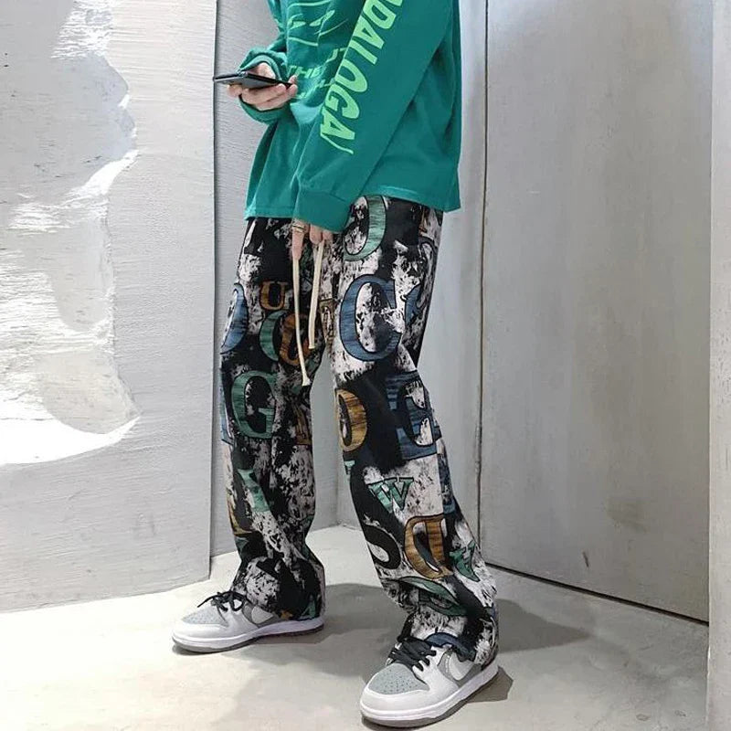 Black white and multicolored high street graffiti cargo trousers man american with drawstring waistband and loose fit
