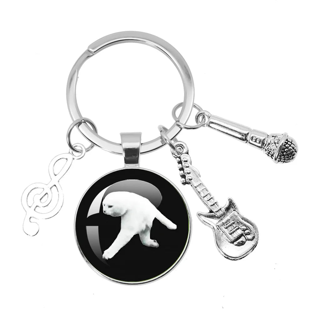 Silver themed keychain jewelry featuring a black glass charm with white cat silhouette and aphex twin logo backpack accessories souvenir