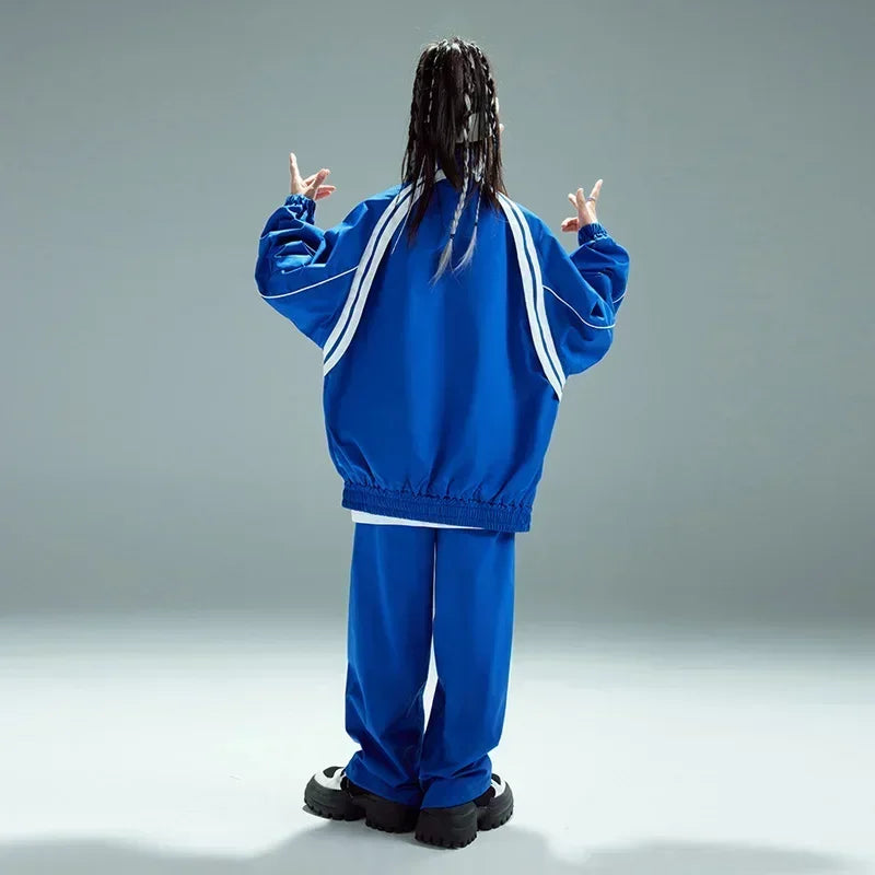 Blue athletic tracksuit with white stripe detailing on sleeves and back shown from the back for kids hip hop streetwear