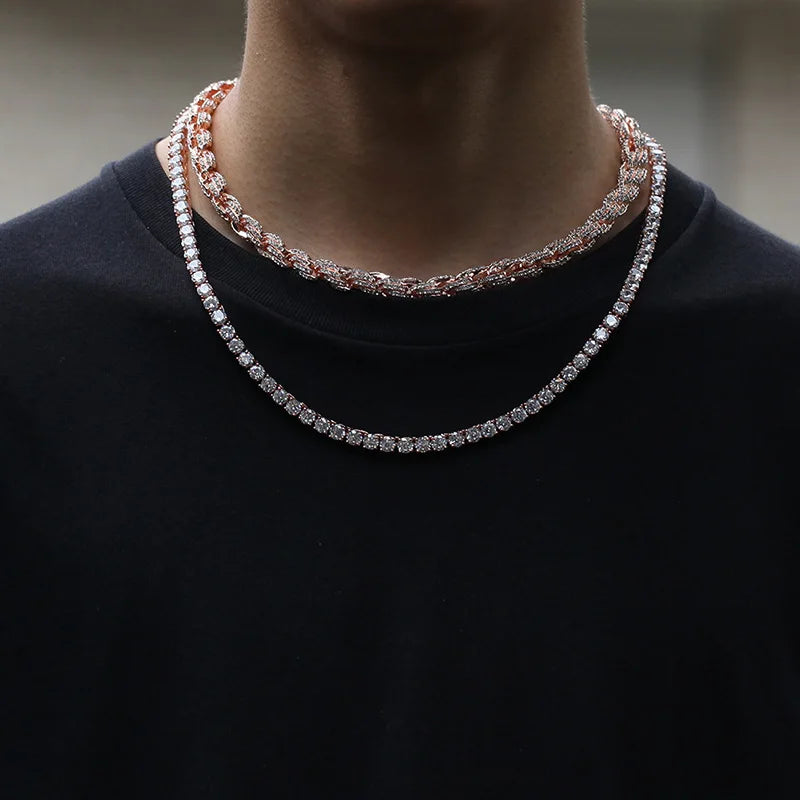 A person wearing two layered hip hop full Austrian rhinestone paved round rope link chain necklaces in rose gold and silver for men rapper jewelry