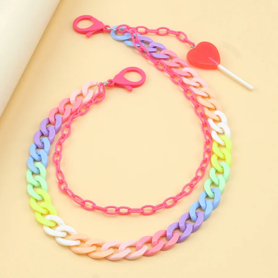 Hip hop rainbow resin chain keychain with multicolor acrylic heart and pink lobster clasps featuring a red lollipop charm