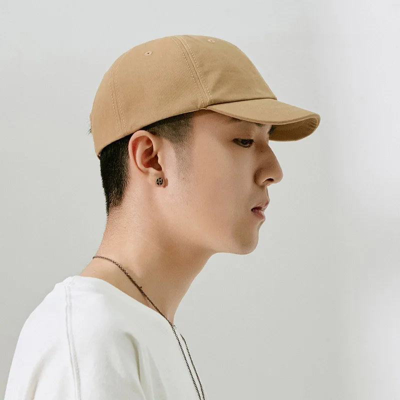 Tan hip hop retro brim baseball hat made of soft cotton adjustable with stitched panels for casual streetwear use