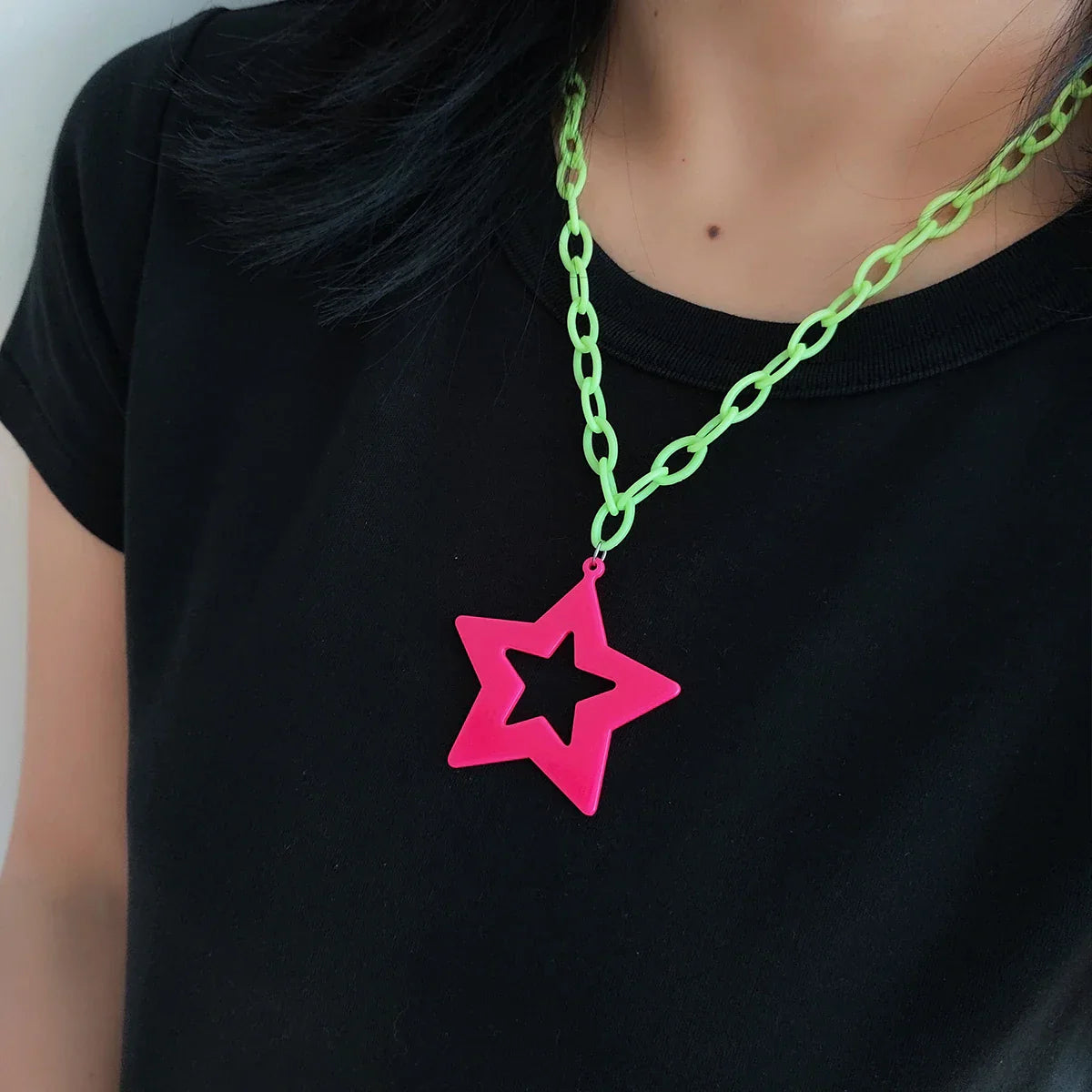 A vibrant neon pink acrylic fluorescent star pendant with a bright lime green sweater chain necklace for rock exaggerated personality style