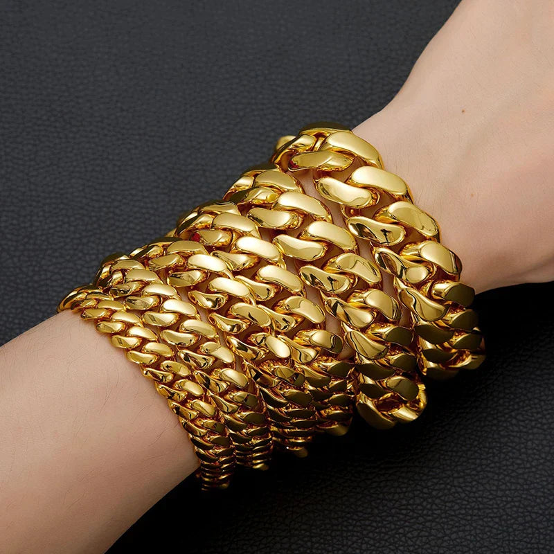 A stack of thick gold-colored stainless steel rhombus cuban miami link bracelets worn as hip hop rock rapper jewelry gold
