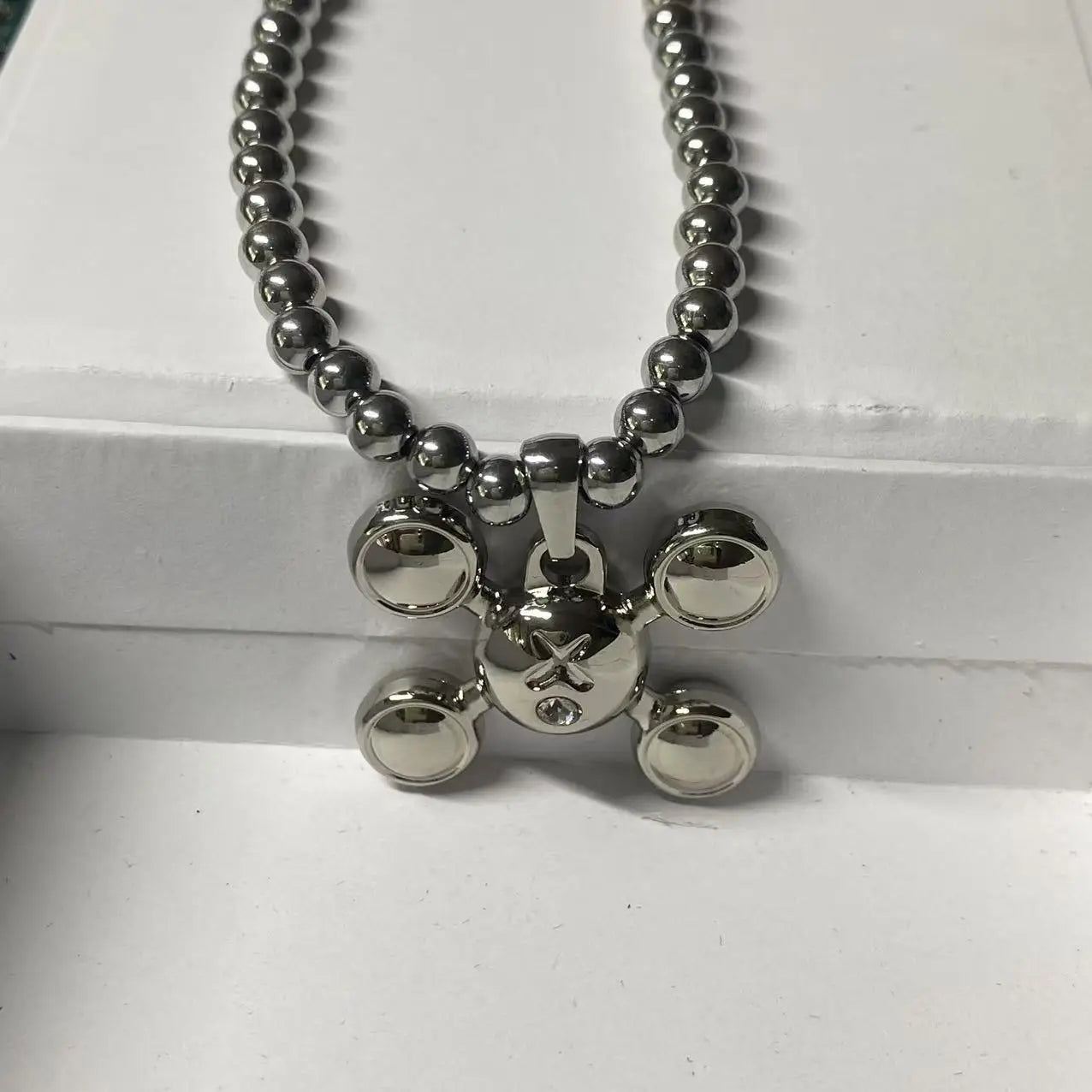 Silver metallic skull pendant necklace with circular openings on a stainless steel bead chain rapper design necklace gift