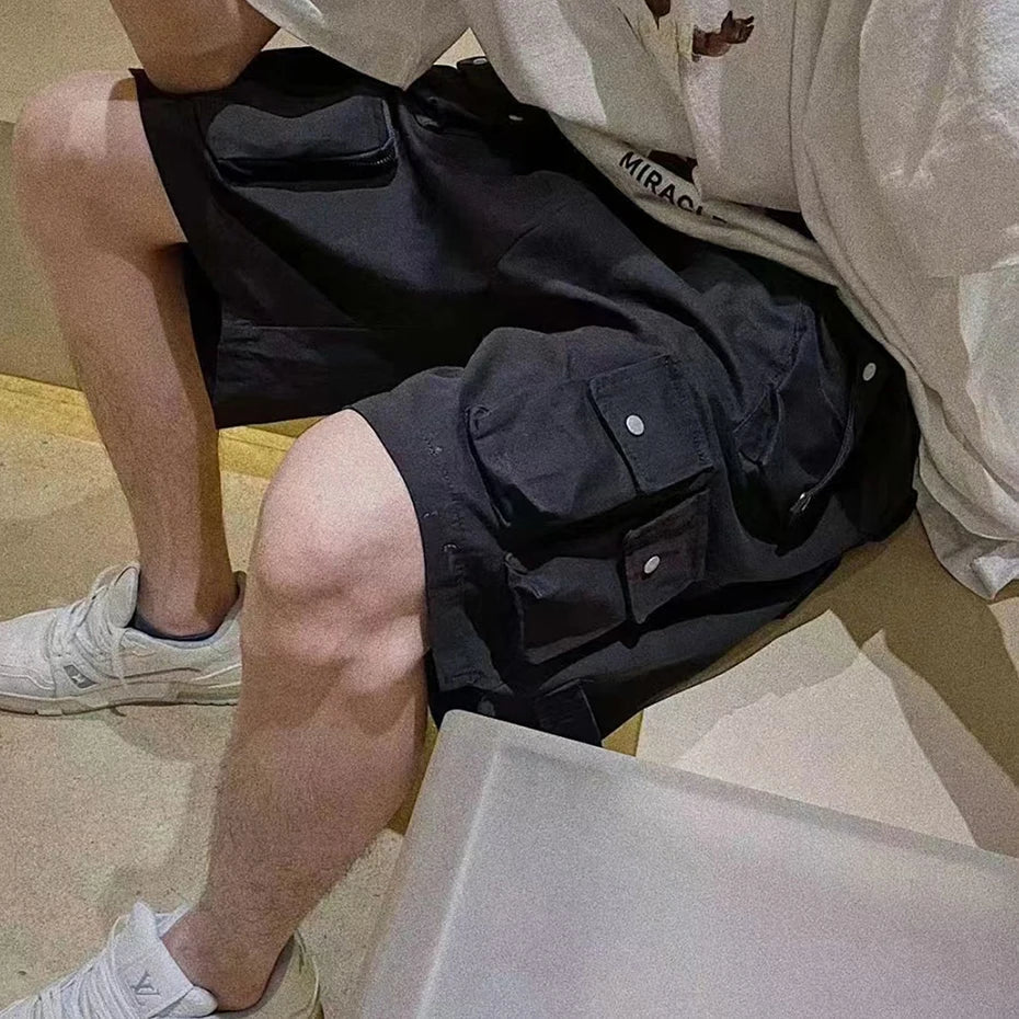 Black hip hop y2k streetwear cargo shorts with multiple pockets and silver button closures for casual summer wear
