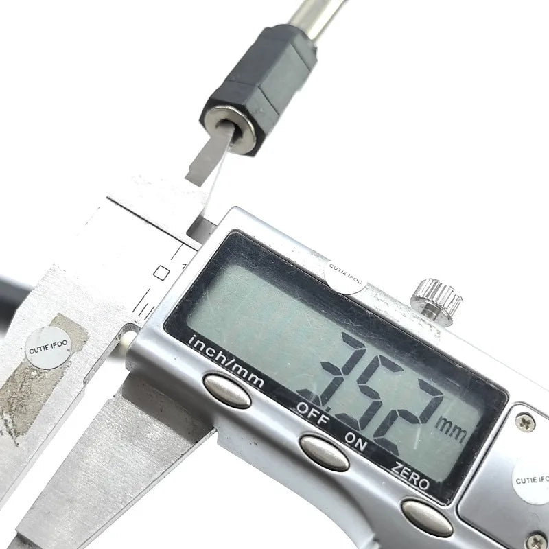 Silver digital caliper measuring 7.52 mm on black metallic drum plug headphone used as electronic drum adapter converter jack