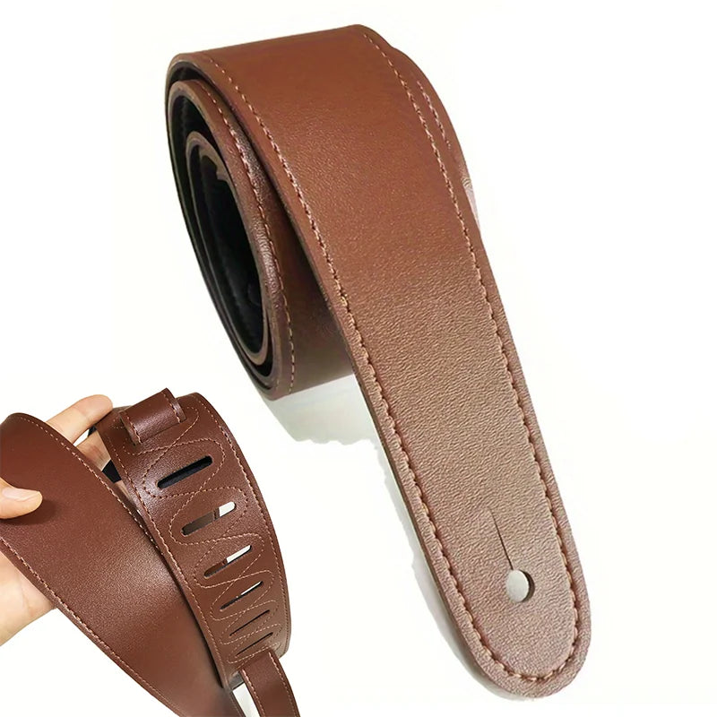 Brown leather guitar strap with stitched edges and decorative cut-out pattern for electric acoustic bass guitars