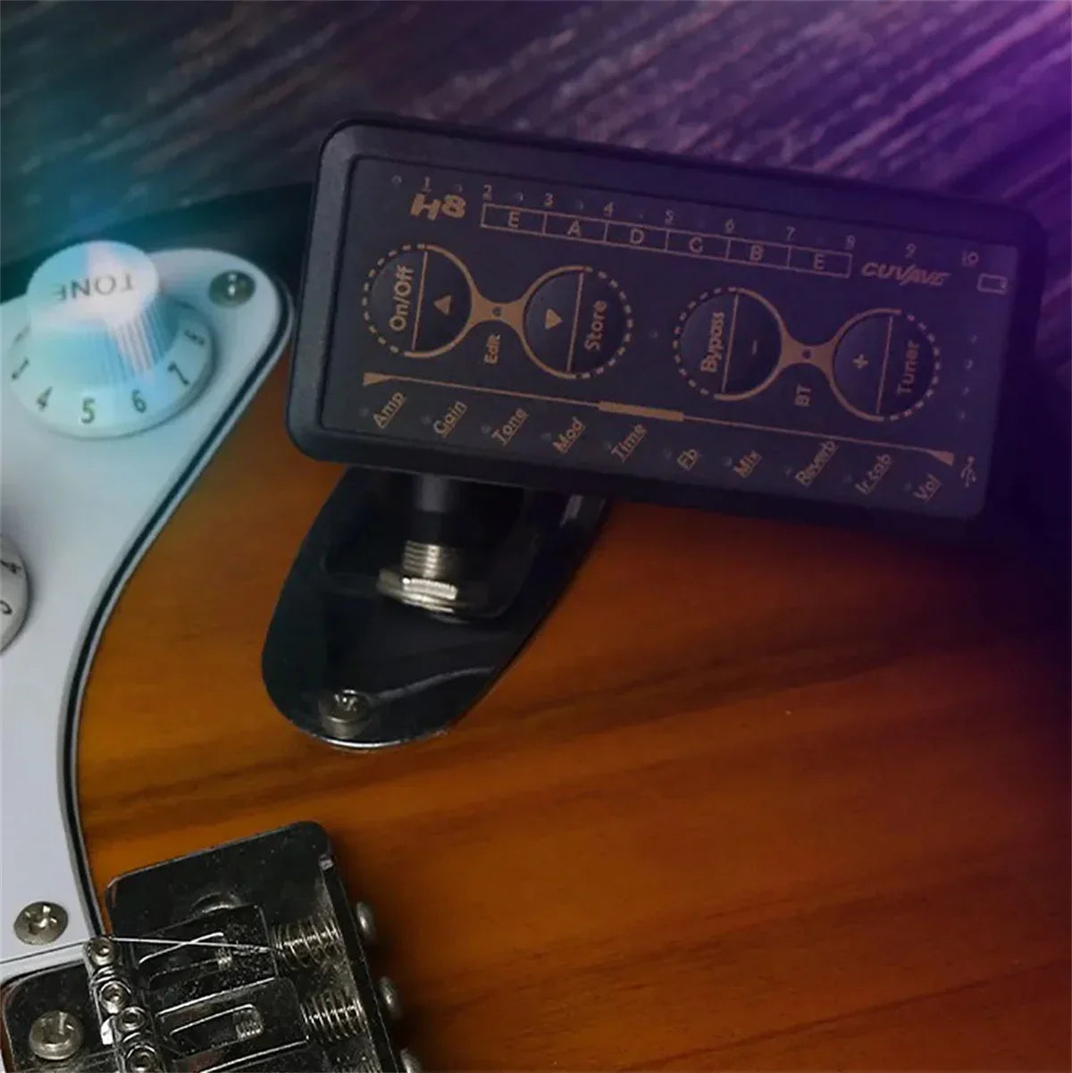Black h8 guitar headphone amplifier with gold knobs mounted on wood featuring delay reverb effect for internal recording