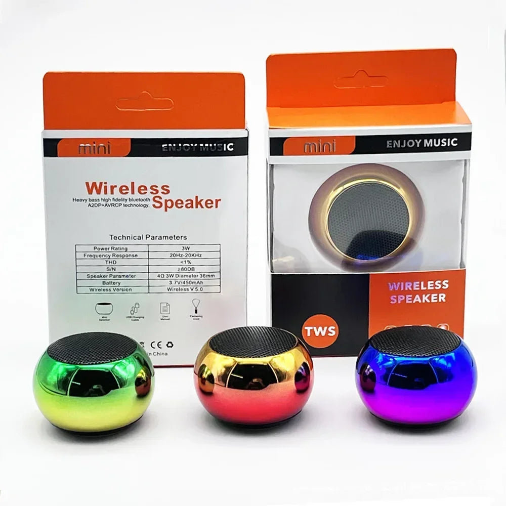 Three colorful spherical mini wireless bluetooth speakers in green gold and purple with glossy metal finishes