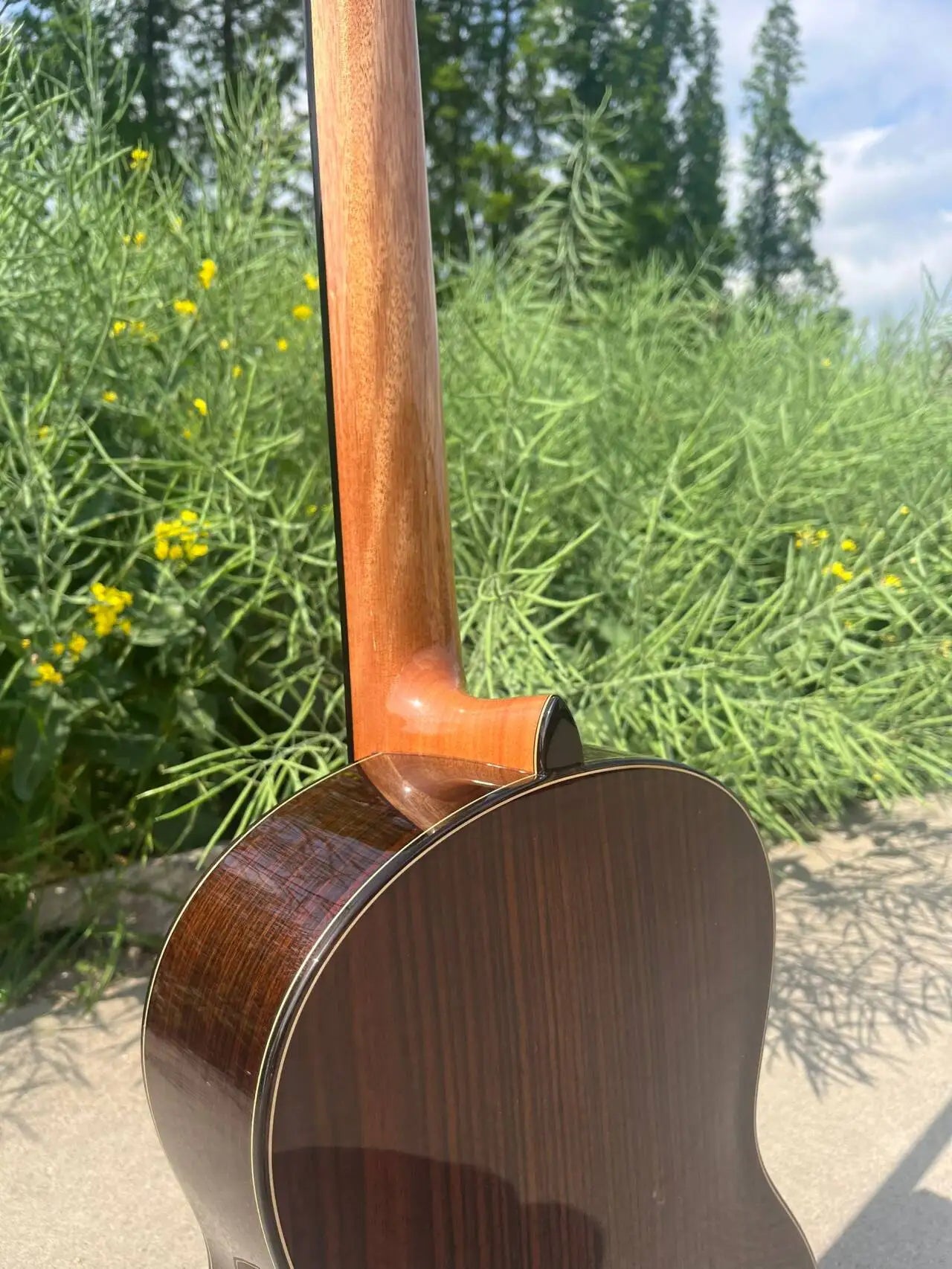 A polished dark brown master level aiersi classical guitar with glossy finish and level aiersi lattice bracing