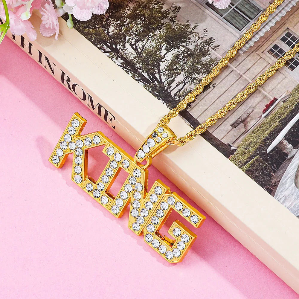 Gold-colored hip hop king pendant necklace with clear rhinestones on a cuban link chain for fashionable jewelry gift