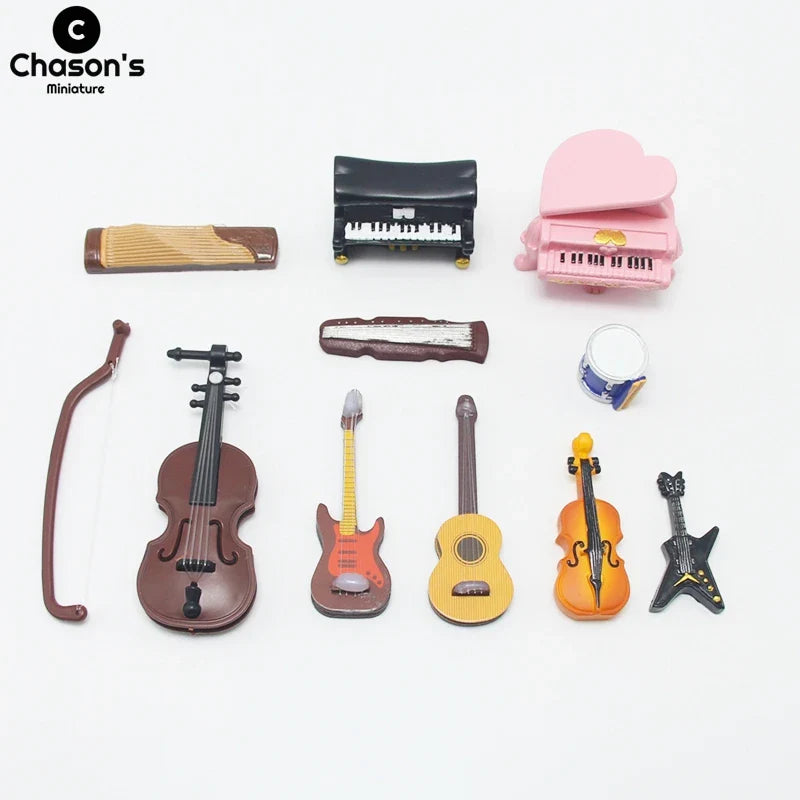 A collection of miniature musical instruments including a brown violin, red electric guitar, pink piano, and black upright piano