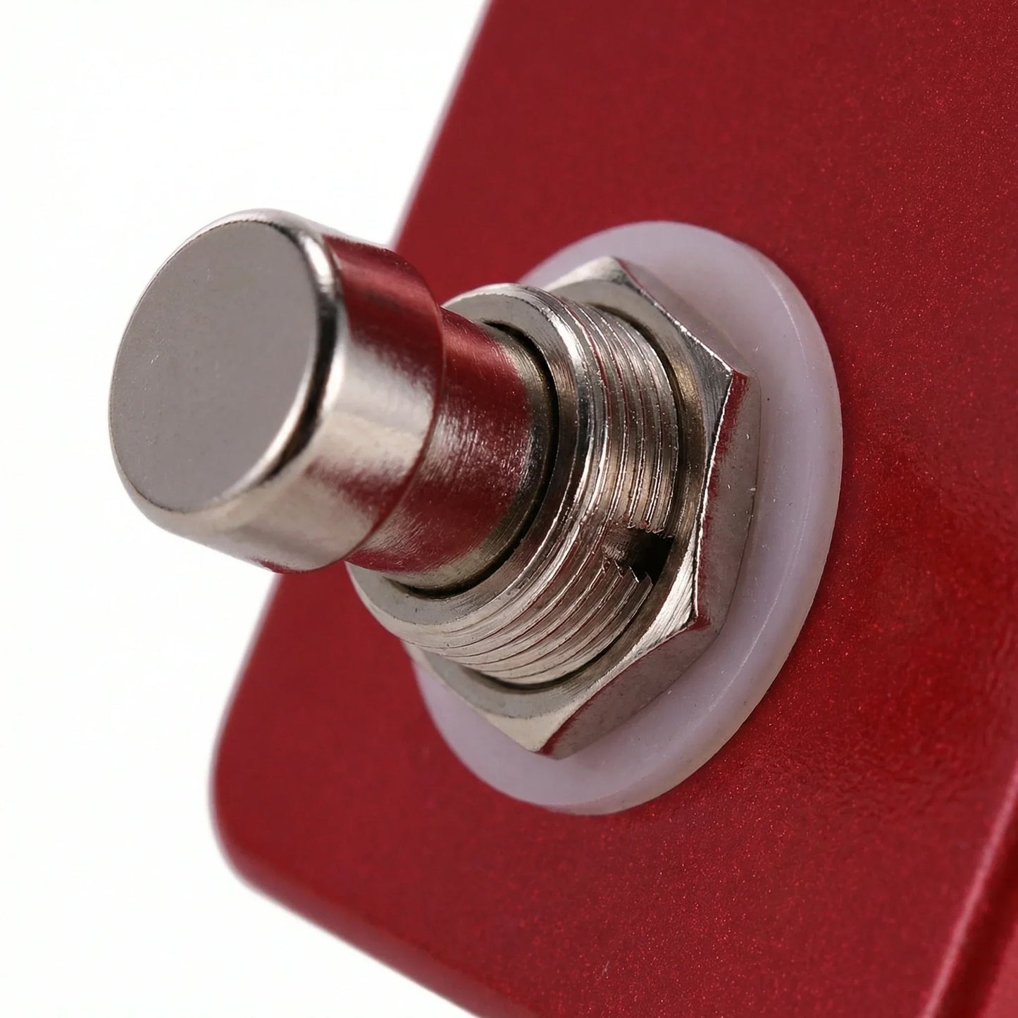 A metallic toggle switch with a silver knob on the red panel of the moskyaudio dc5 guitar distortion overdrive booster pedal