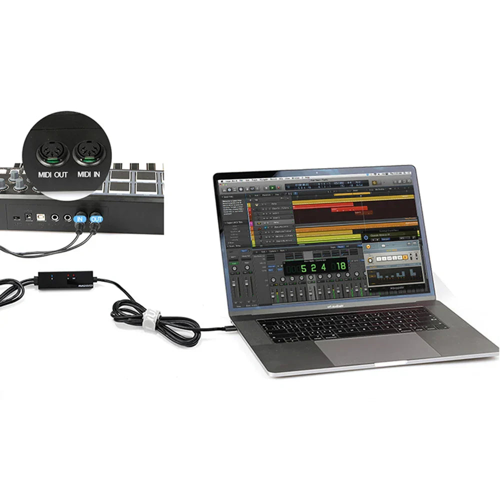 Black midi interface with labeled ports connected via mtu-11 midi usb cable lead adapter to a laptop for music production
