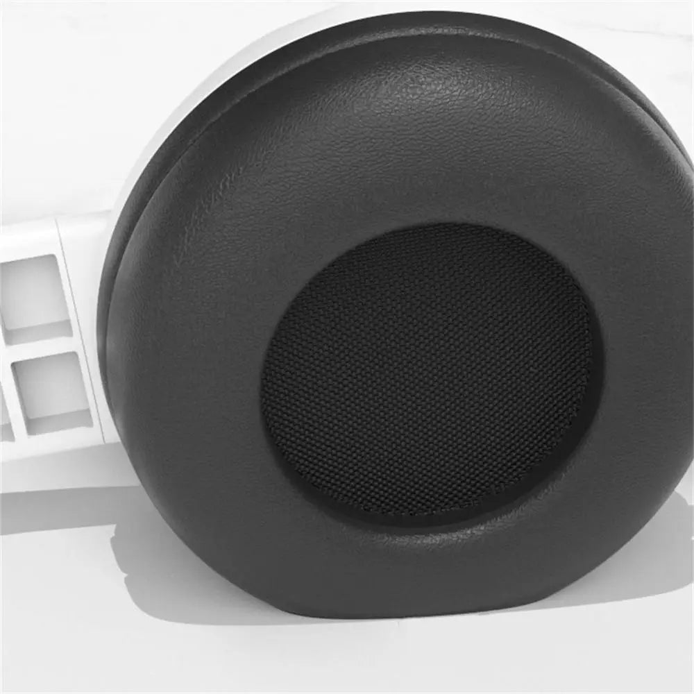 Black circular earpad with textured outer surface and mesh inner circle for adjustable audio bass macaron headphone tablet headset