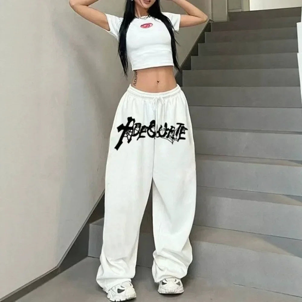 White cropped t-shirt with small pink logo paired with high waist hip hop jazz wide leg sports trousers