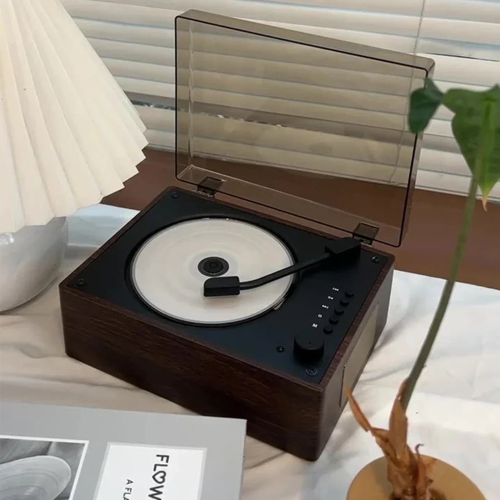 Dark wood grain portable retro cd player with transparent acrylic lid and black vinyl-style platter featuring built-in 2000ma lithium battery