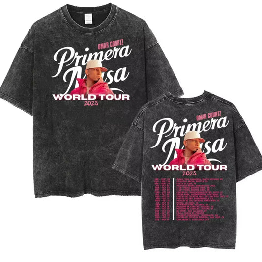 Black distressed cotton t-shirt featuring omar courtz graphic in pink jacket and white cap with primera masa world tour 2025 text