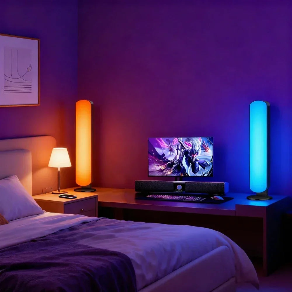 Two cylindrical smart led lamps glowing orange and blue on a desk showcasing rgb usbled light with backlight remote symphony features