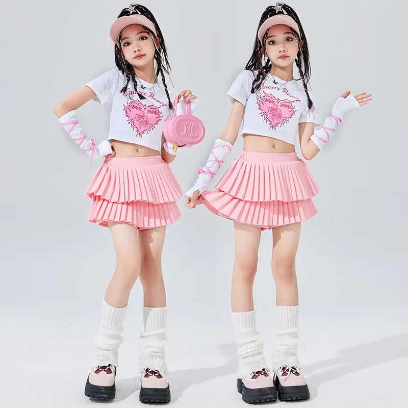 Pink circular handbag with prominent x logo complementing rosa mangas minifalda plisada en capas outfit for girls