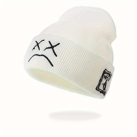 White knitted hat with sad face embroidered graphic brimless beanie and small logo patch for casual wear