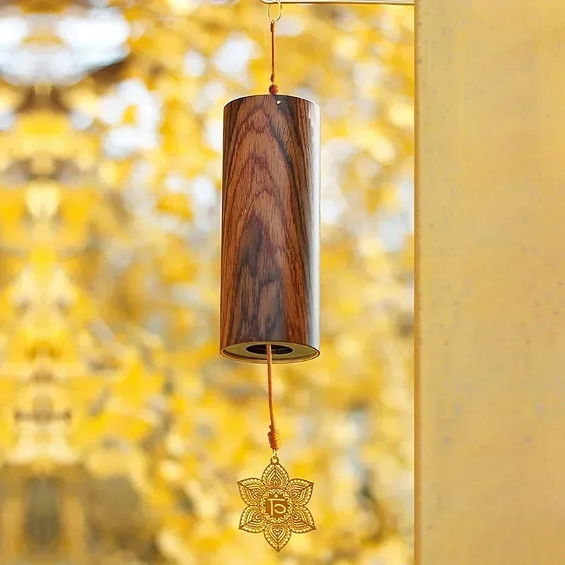 A polished wooden seventh chord wind chime with dark brown grain and golden lotus charm for meditation yoga japanese use