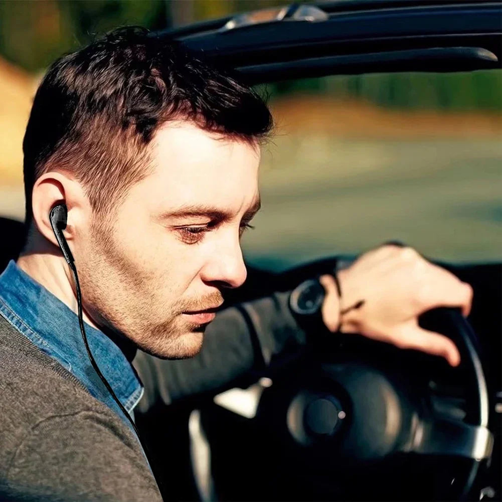 Black single sided wired mono headphone earbud worn by man driving for walkie talkie multifunctional use