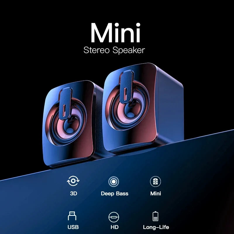 Pair of sleek glossy black mini home musical stereo speakers with vibrant blue and pink drivers for desktop computer laptop use