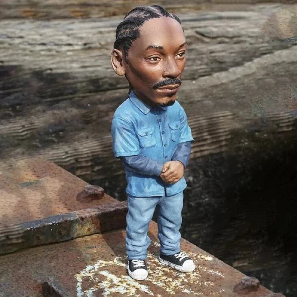 A detailed bobblehead figurine of Snoop Dogg in light blue outfit and sneakers perfect as a rapper star cool hip hop guy ornament