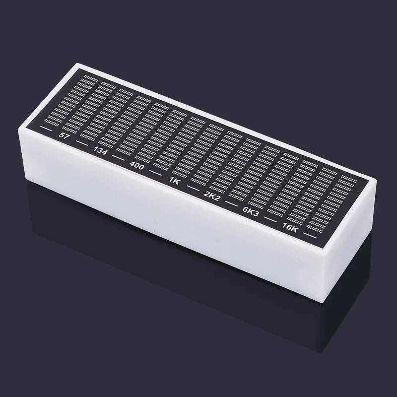 White rectangular polishing stone with black abrasive surface marked by grit levels used for led pickup rhythm analyzer light display